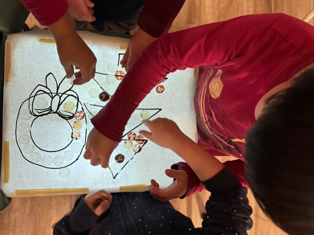 Teacher reading a picture book to children seated in a circle at storytime
