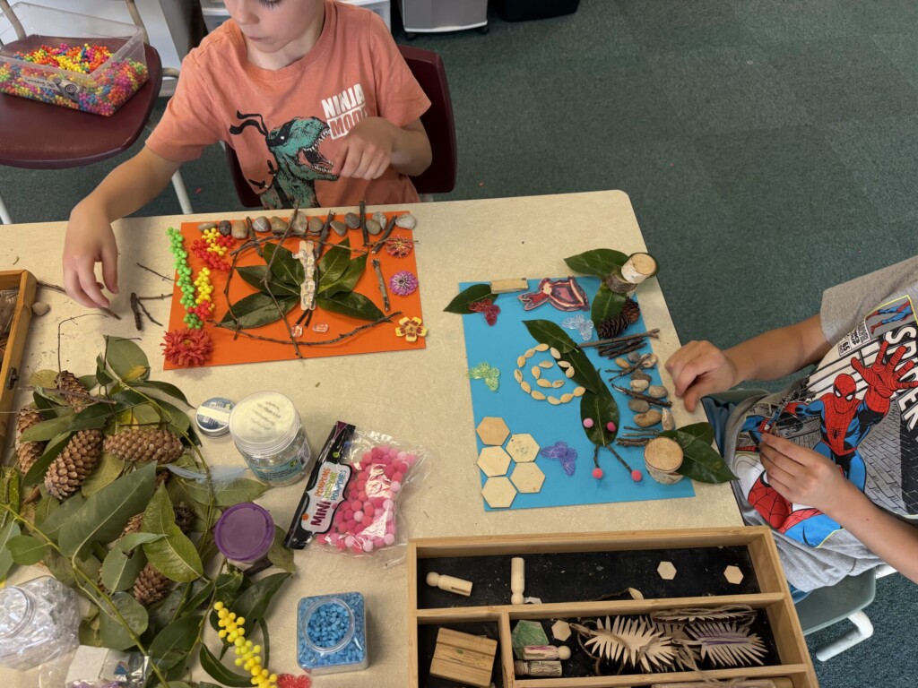Children creating a nature collage with leaves, pinecones, and pom-poms